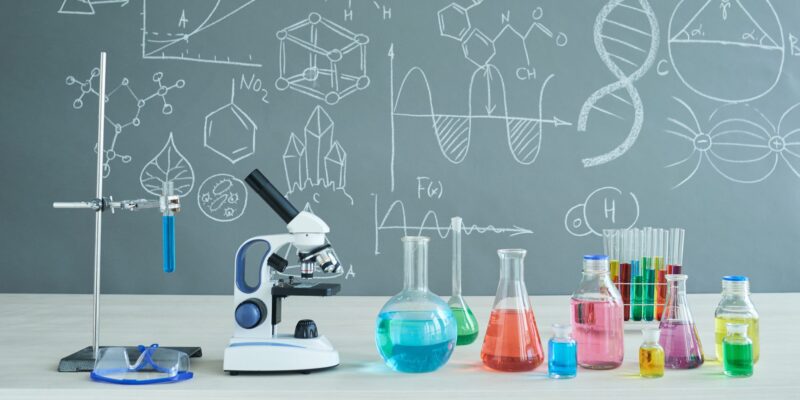 Interior of Chemistry Classroom Interior of modern chemistry classroom: desk with microscope and laboratory glassware, blackboard - Science Resources for Middle and High School